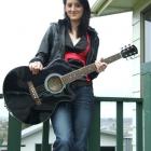 Singer-songwriter Vickie Evans outside her home in Balclutha, with the guitar she won at the...