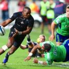 Siyanda Grey of the Southern Kings gets past Highlanders tacklers during their Super Rugby match...