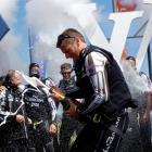 Skipper Dean Barker and Emirates Team New Zealand spray champagne after winning the 30th...