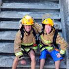 Firefighter Richard Yardley (left) and his ‘‘technical assistant'' Brodie Carvalho take a...