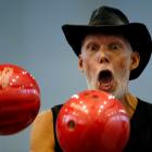 Slovakia's Milan Roskopf juggles with bowling balls as he tries to break a record during the...