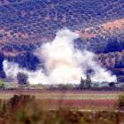 Smoke rises after a mortar bomb fired from Syria landed in Turkish soil on the Turkish-Syrian...