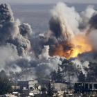 Smoke rises over the Syrian town of Kobani after an air strike from the US-led military coalition...