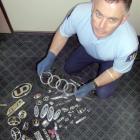 Snr Const Ian Henderson with a cache of car badges discovered while investigating a complaint of...