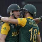 South Africa's AB de Villiers (L) and Faf du Plessis celebrate their 100 run partnership during...