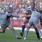 South Africa Stormers Andries Bekker, centre, is tackled by New Zealand's Hurricanes Cory Jane,...