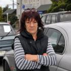 South Dunedin resident Maree McIntosh stands among the parked cars for sale in Hillside Rd this...