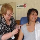 Southern District Health Board nurse co-ordinator Yvonne Stewart administers ''the flu jab'' to...
