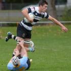 Southern flanker Adam Knight tries to escape the clutches of University A first five-eighth...