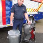 Southern Region fire service officer Stuart Ide demonstrates the damage hot ashes can do to a...