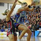 Southern Steel centre Wendy Frew grabs the ball in front of her Melbourne Vixens counterpart,...