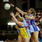 Southern Steel goal keep Leana de Bruin reaches over Central Pulse goal shoot Caitlin Thwaites to...
