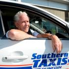 Southern Taxis driver George Kennedy was back on the job yesterday after his taxi was swept down...