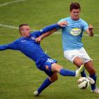Southern United player Morgan Day (left) and Wanderers player Mario Ilich compete for the ball...