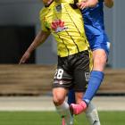 Southern United's Sam Redwood jumps above Joel Stevens, of the Wellington Phoenix, to head the...