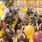 Southland captain Jamie Mackintosh holds the Ranfurly Shield aloft as he is swamped by fans at...