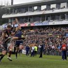 Southland halfback Scott Cowan has his kick charged down by Otago fullback Ben Smith at...