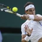 Spain's Rafael Nadal returns against Britain's Andy Murray in their semifinal match at Wimbledon....