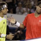 Spain's Rafael Nadal, right, reacts as he talks with compatriot David Ferrer at the net after his...