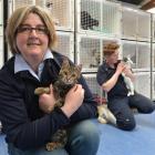 SPCA Otago executive officer Sophie McSkimming (left) and animal attendant Maartje Hyink cuddle...