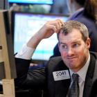 Specialist Gregg Reilly works on the floor of the New York Stock Exchange. Photo from AP.