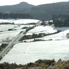 Spring Snow covers the hills either side of the Northern Motorway near Pigeon Flat, north of...