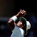 Sri Lanka's Dhammika Prasad catches out Australia's David Warner during the second day's play of...