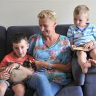 Stacey Jefferies, who had a mastectomy a year ago, with sons Cole, holding Coco the cat, and...