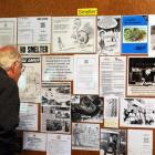 Stan Hughes, of Dunedin, takes in the exhibition about the settlement held at the Aramoana Hall....