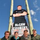 Standing beneath the billboard of  Waitaki Valley hero Richie McCaw in Kurow are (from left)...