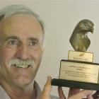 Steve Lawrence, of Outram, with the conservation award he received for his work with falcons....