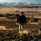 Strath Taieri farmer Ron Jones and his dog Pip walk across bone-dry ground in August, 1998, after...