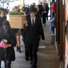 Students and environmentalists carry a coffin through Dunedin to raise awareness of environmental...