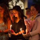 Students and staff members attend a candle light vigil on Boston University Campus in Boston,...