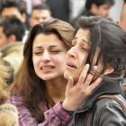 Students grieve after a fellow student shot dead his American teacher at a school in Sulaimaniya,...