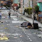 Students survey the mess after Saturday's Hyde St keg party. Photo by Stephen Jaquiery.