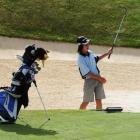 Sungwoo Han (13), of Queenstown, plays from the bunker during his round on The Hills course in...