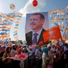 Supporters hold a poster of Turkish Prime Minister Tayyip Erdogan during a mass rally in Istanbul...