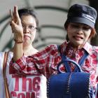 Supporters of an anti Thailand coup protester, Sombat Boonngamanong, flash the three-finger sign...