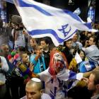 Supporters of Prime Minister Benjamin Netanyahu's Likud party celebrate after the exit polls were...
