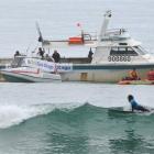 Surf life-savers speak to fishermen sitting off St Clair during an anti-drilling protest at the...