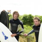 Surfers (from left) Tony Denley (32), Tom Leckie (24) and Dillon Ryan (33) were surfing during  a...