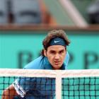 Switzerland's Roger Federer watches the ball go over the net as he returns to Colombia's...