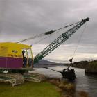 Syd Hogg operates a dragline dredger in the boat harbour at Lake Waihola. Photo by Jane Dawber.