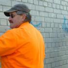 Taskforce Green workers Trevor Smith (left) and Greg Street paint over graffiti in Melbourne St,...