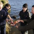 Tahuna Intermediate pupils Mhairi Duncan (12), left, and Kopare Williams (11) touch a rainbow...