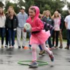 Taieri Beach School pupil Hannah Jaquiery (6) shows students from High Point University, North...