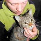 Tapanui woman Gemma Perry with her cat Slinky, which lost her leg after being left in a trap for...