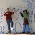 Tape artists Struan Ashby and Erica Duthie at work in the Octagon yesterday. Photo by Peter...