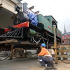 Tayler McKay, of Fulton Hogan, (top) watches as Josephine sits aloft, ready to be transferred on...